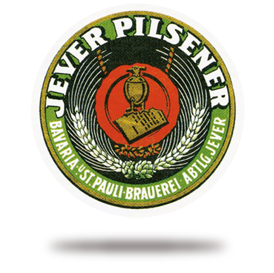 Ein kreisförmiges Logo mit grünem Ring und zentral einem roten Wappenschild.