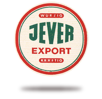 Rundes Logo mit grüner, weißer und roter Beschriftung, schwarzer Hintergrund.