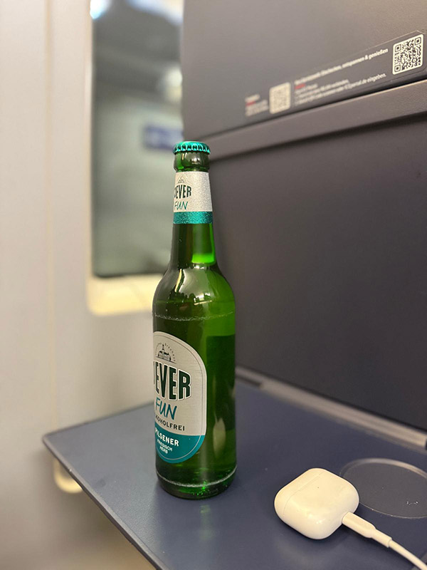 Eine Jever-Bierflasche steht auf einem kleinen Klapptisch einer Bahn.