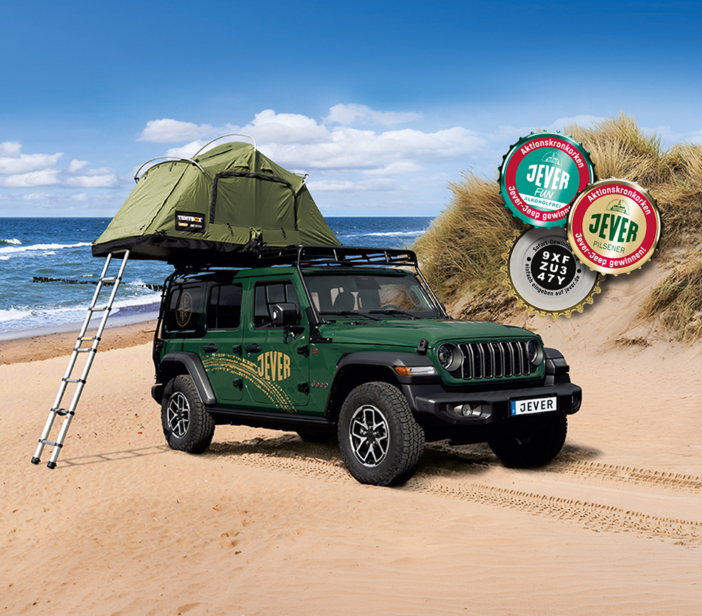 Ein Jever Jeep mit Dachzelt steht am Strand, rechts daneben Kronkorken mit einem eingedruckten Code, dahinter Meer.